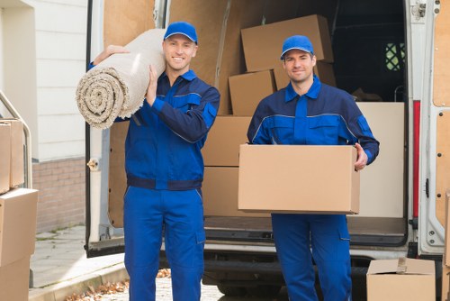 Removal team loading boxes and household items for a West Kensington move