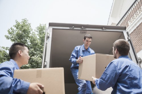 Packed boxes and furniture prepared for a local move in West Kensington