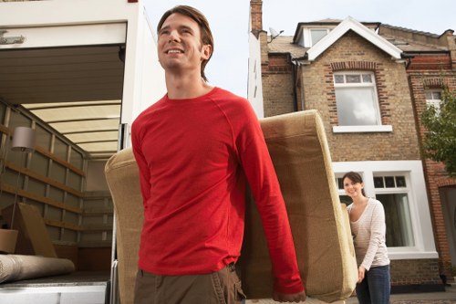 Moving team handling boxes near West Kensington homes