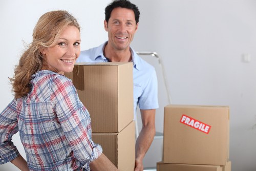 Local removals team planning a move with boxes and furniture in West Kensington